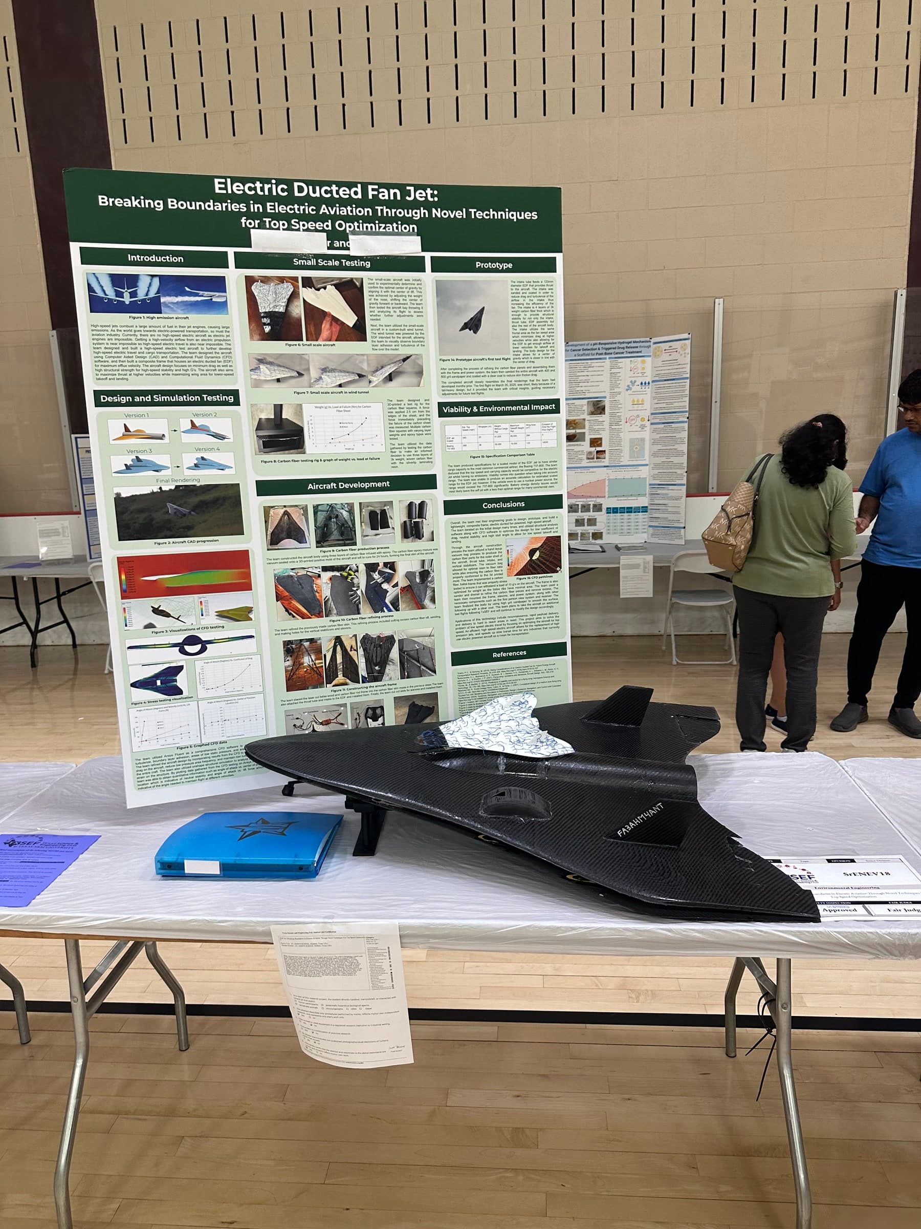 The finished carbon-fiber EDF jet displayed with its research board at the Science and Engineering Fair of Houston